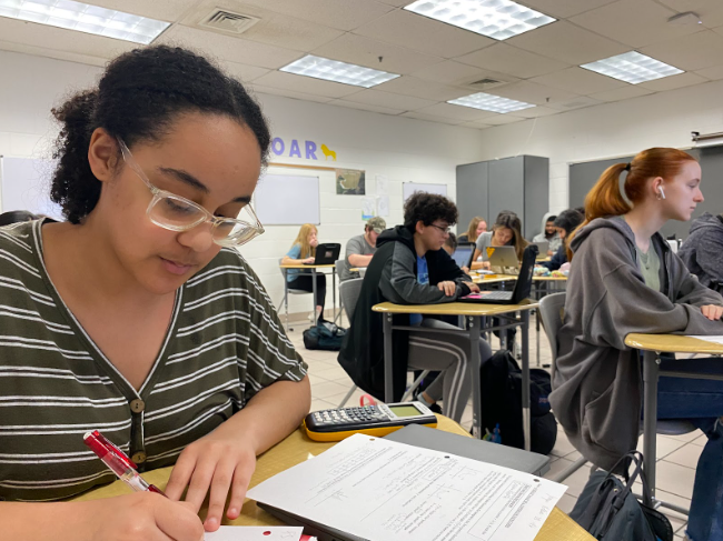 Jasmyne Rollins, 11th grade, prepares for her Ap Calculus class with Cindy Rinehart