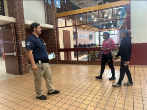 Tallwood security guard Mr. Gibson talks to two Tallwood students in passing.