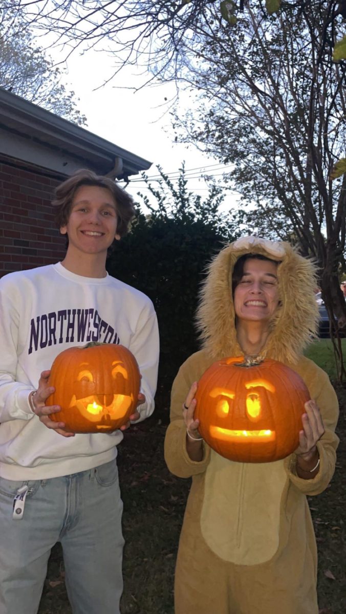 Cameron Sasser and Joshua Hyams display their carved pumpkins